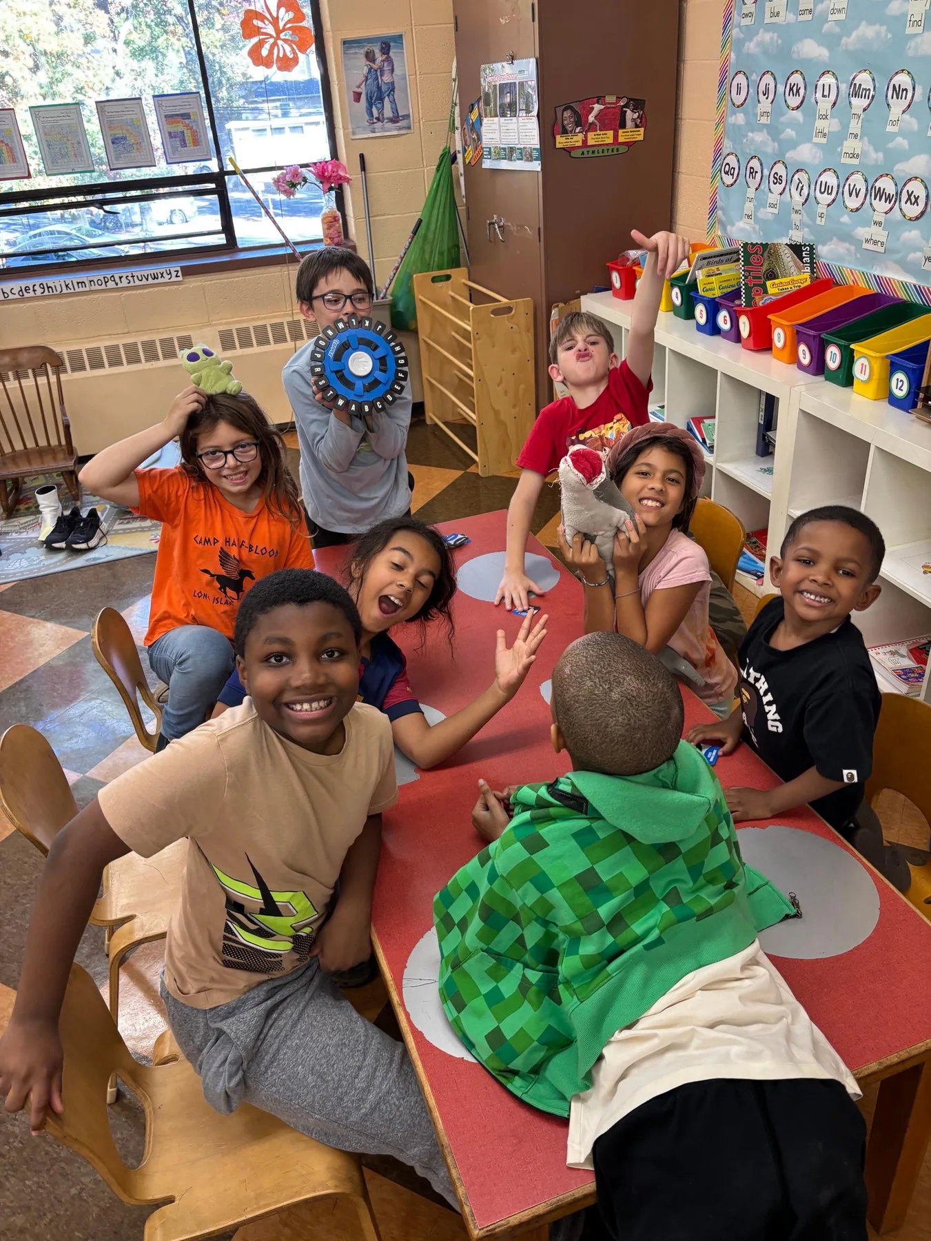Eight Progressive students gathered around a classroom table