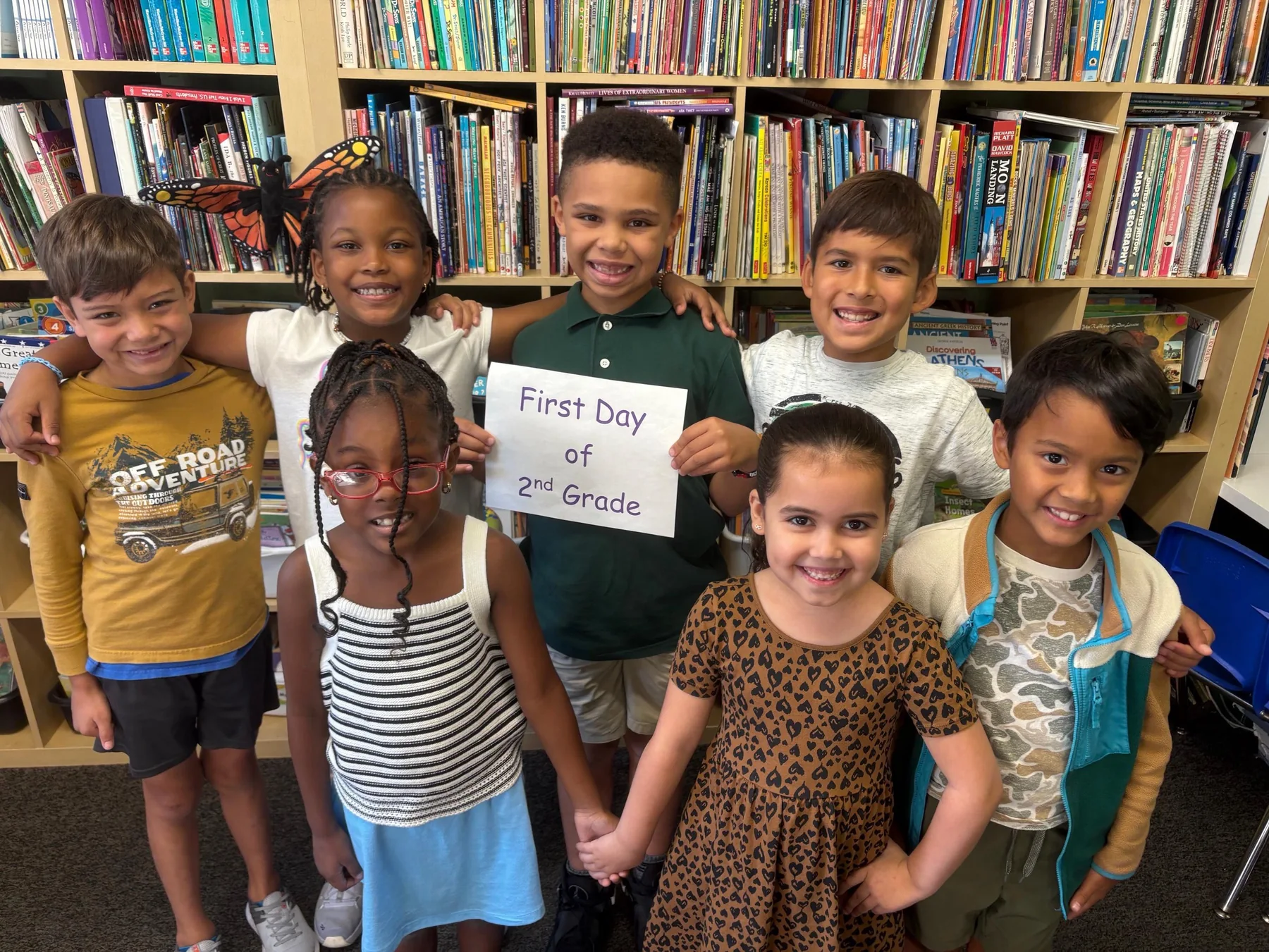 A welcoming group of elementary students in the school library