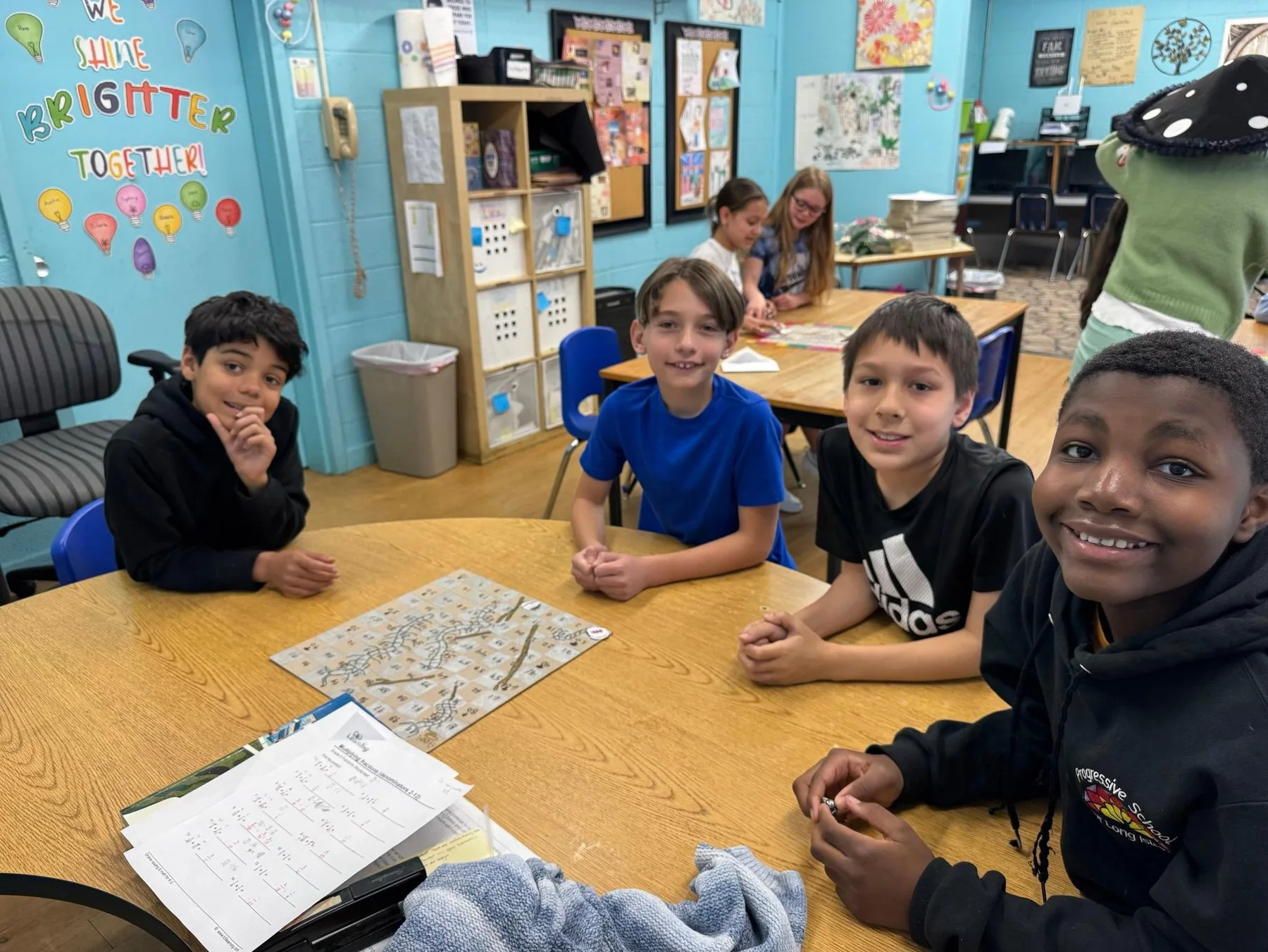 Middle school students collaborating around a table