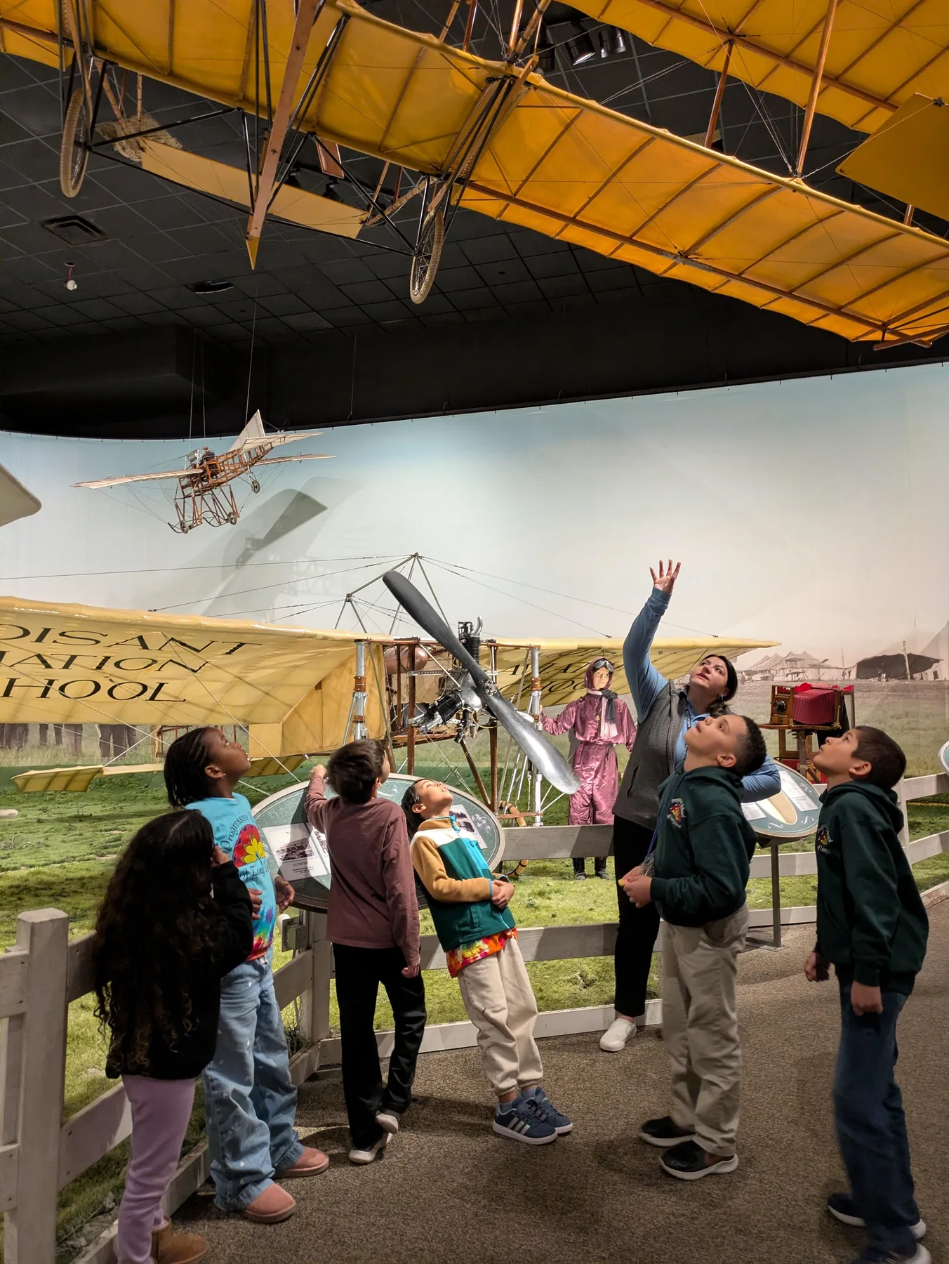 Students observing an aerospace exhibit during a museum visit